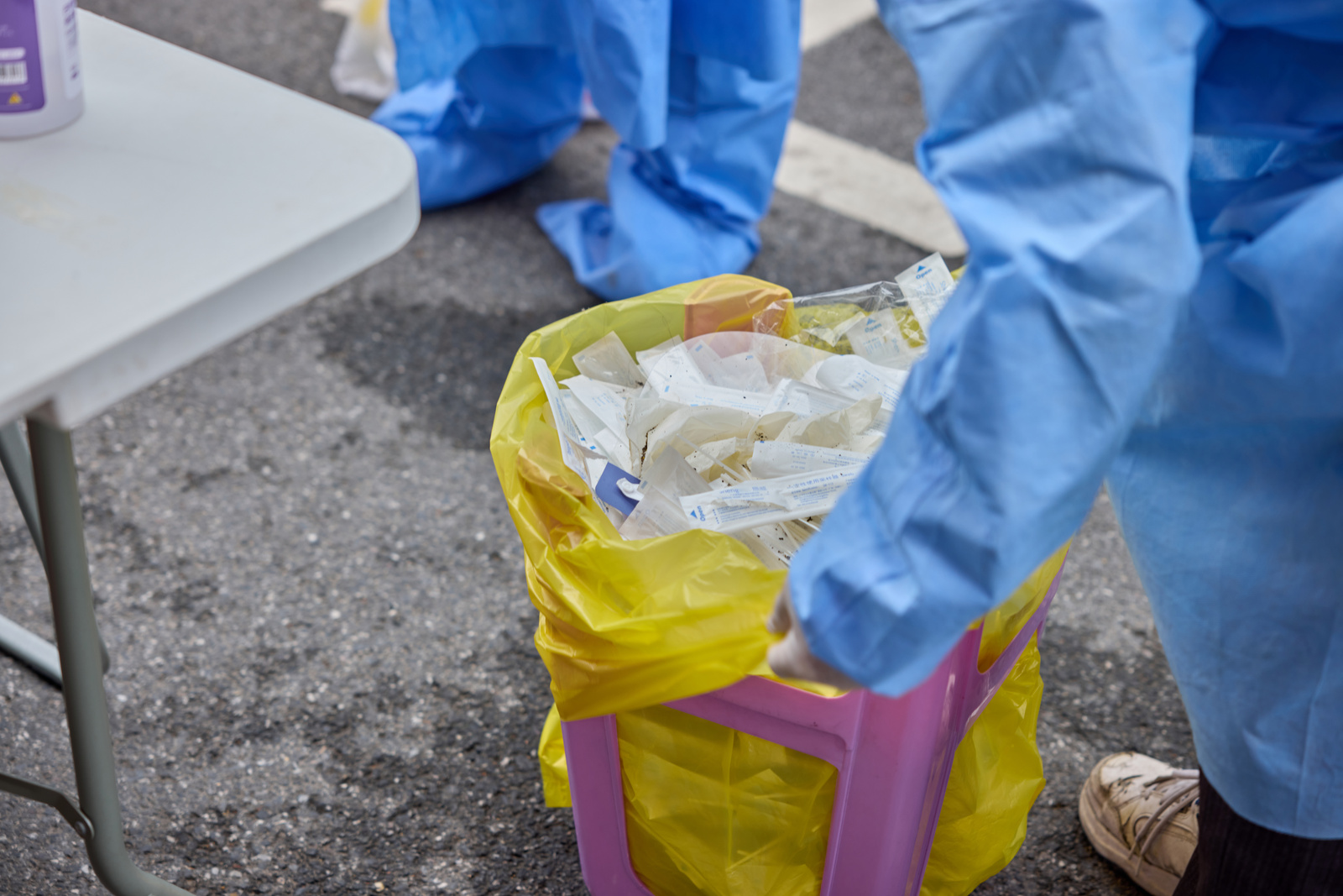Medical worker managing infectious waste.